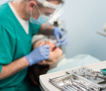 Different professional dental devices, on the blurred background dentist is treating patient in emergency