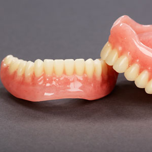 A set of dentures on a gray background