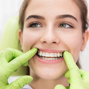 Orthodontic brace control girl in dentist office
