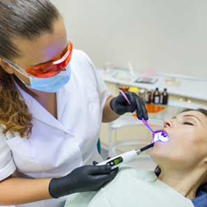 Dentist doing patient's mouth check up using sedation dentistry